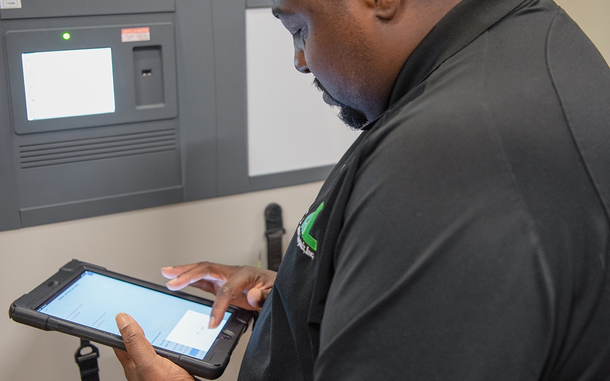 DL Repair tech holding iPad